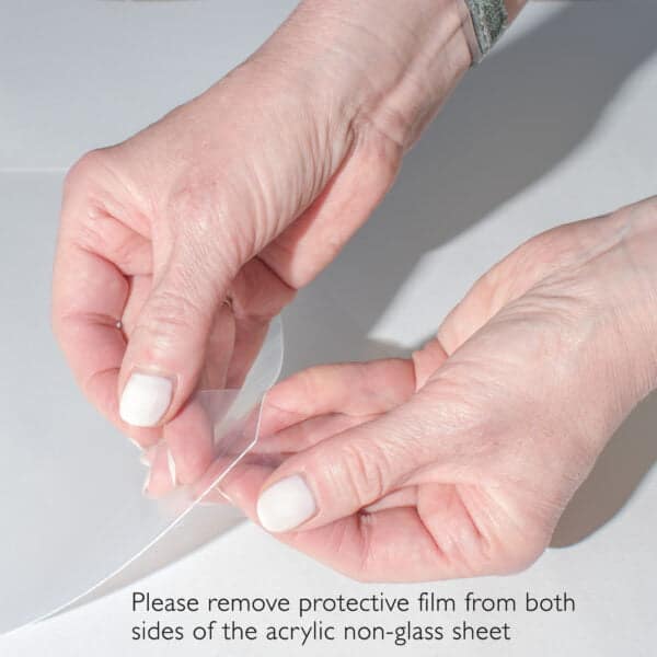 Hands peeling film from acrylic sheet