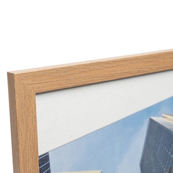 Close-up of wooden frame with partial cityscape photo